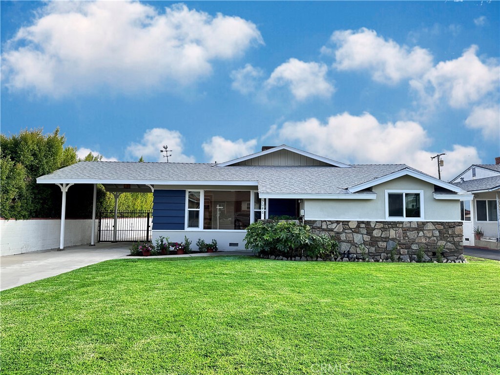 Exterior of Greenwood Avenue, with a green lawn and covered driveway